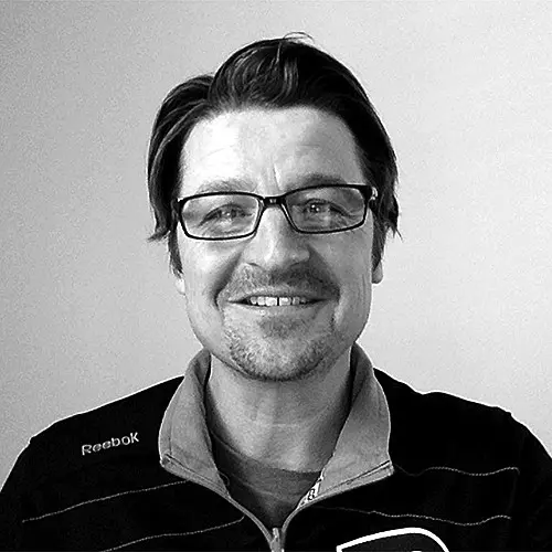 Black and white headshot of Greg Dumont