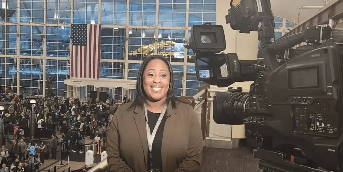 Ashley Forest, master's degree in Communication Management, speaks to a reporter at Denver Airport