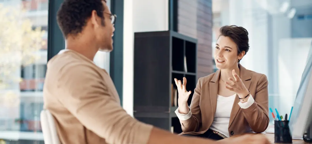 Graduate employment A woman and man speak in an office setting