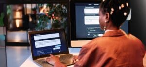 A woman types prompts into a Gen AI engine for a business task.