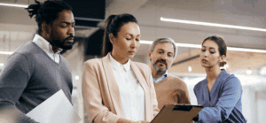 Businesspeople review info on a laptop