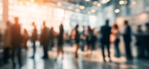 Off-focus photo of an atrium filled with white-collar workers